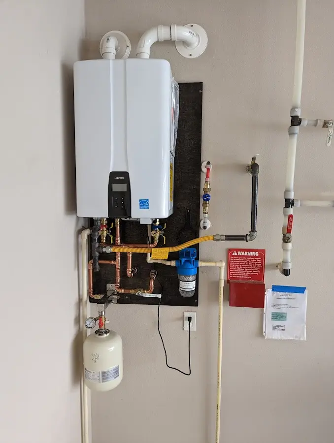 Professional plumber installing copper piping in a White Oak home